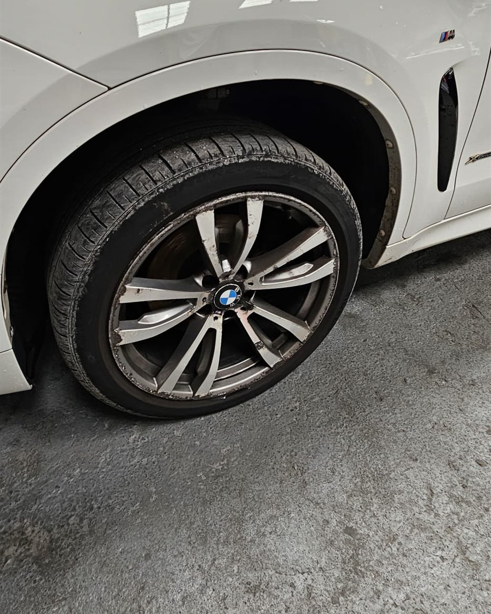 A refurbished alloy wheel back on the car