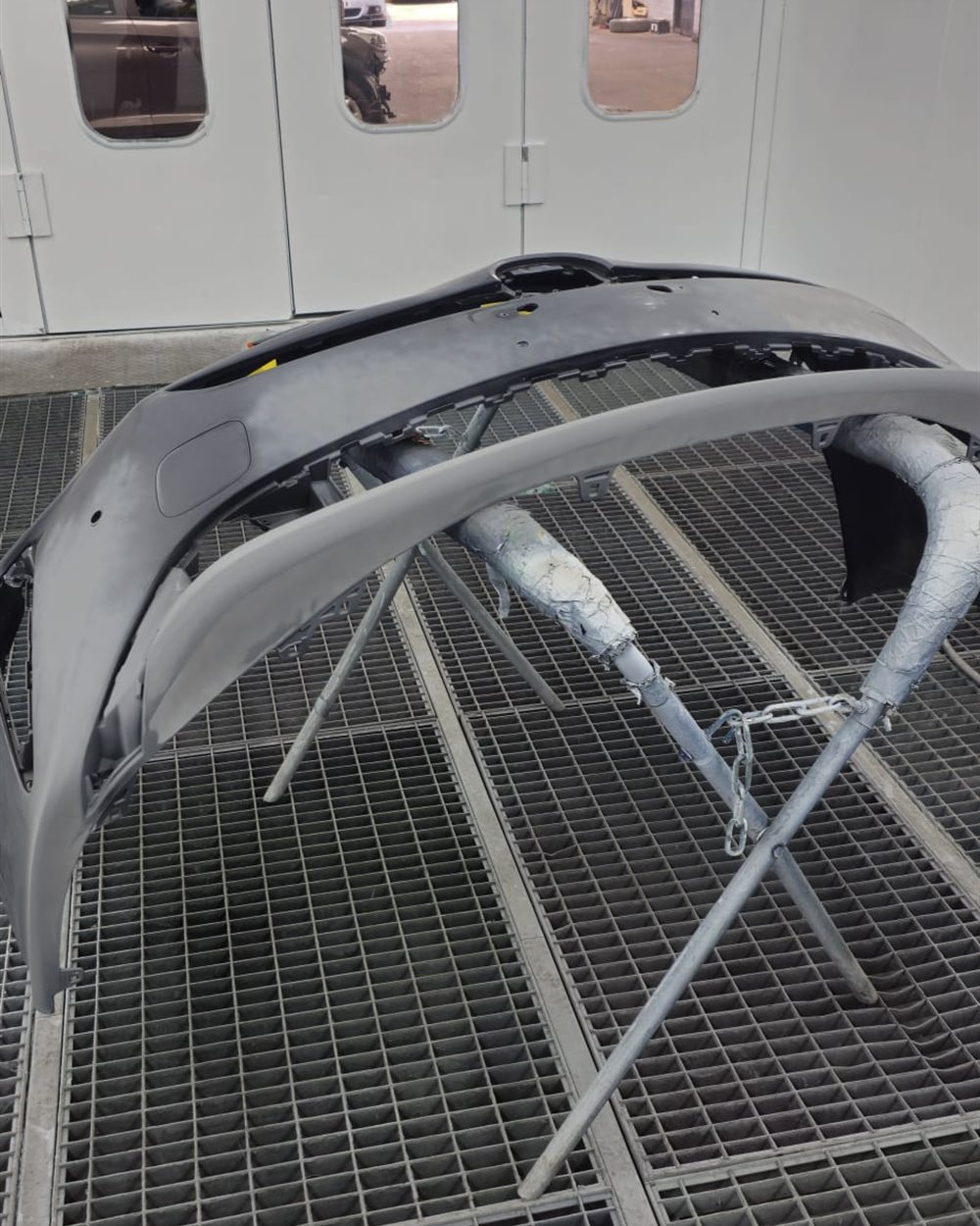 A bumper primed and racked up ready for paint