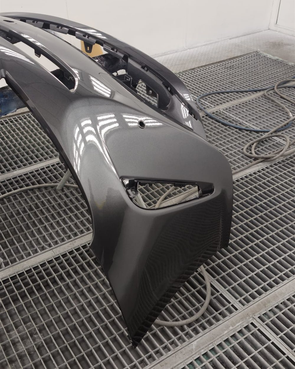 A bumper prepared on the rack before spraying