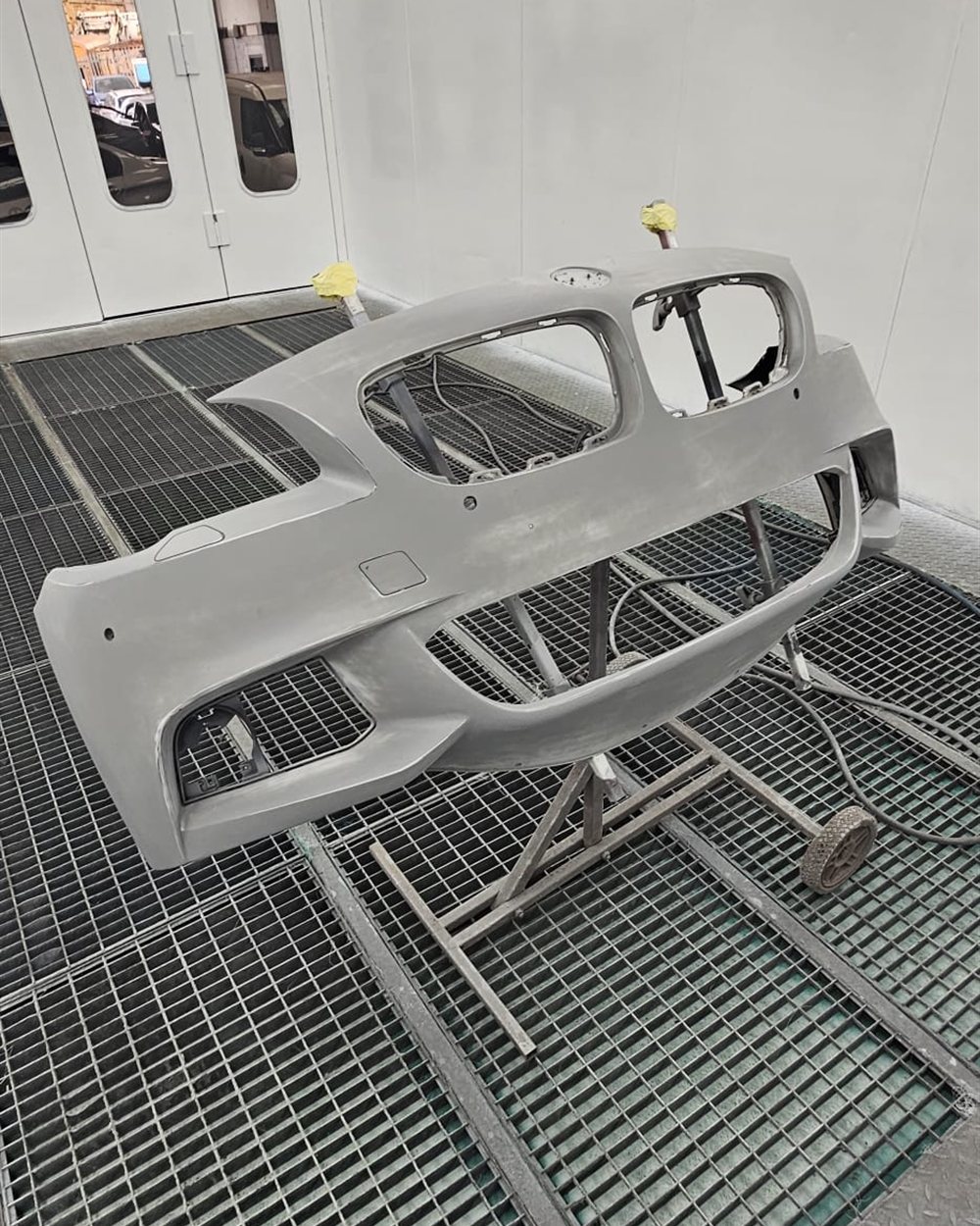 Several panels lined up in the spray booth after priming