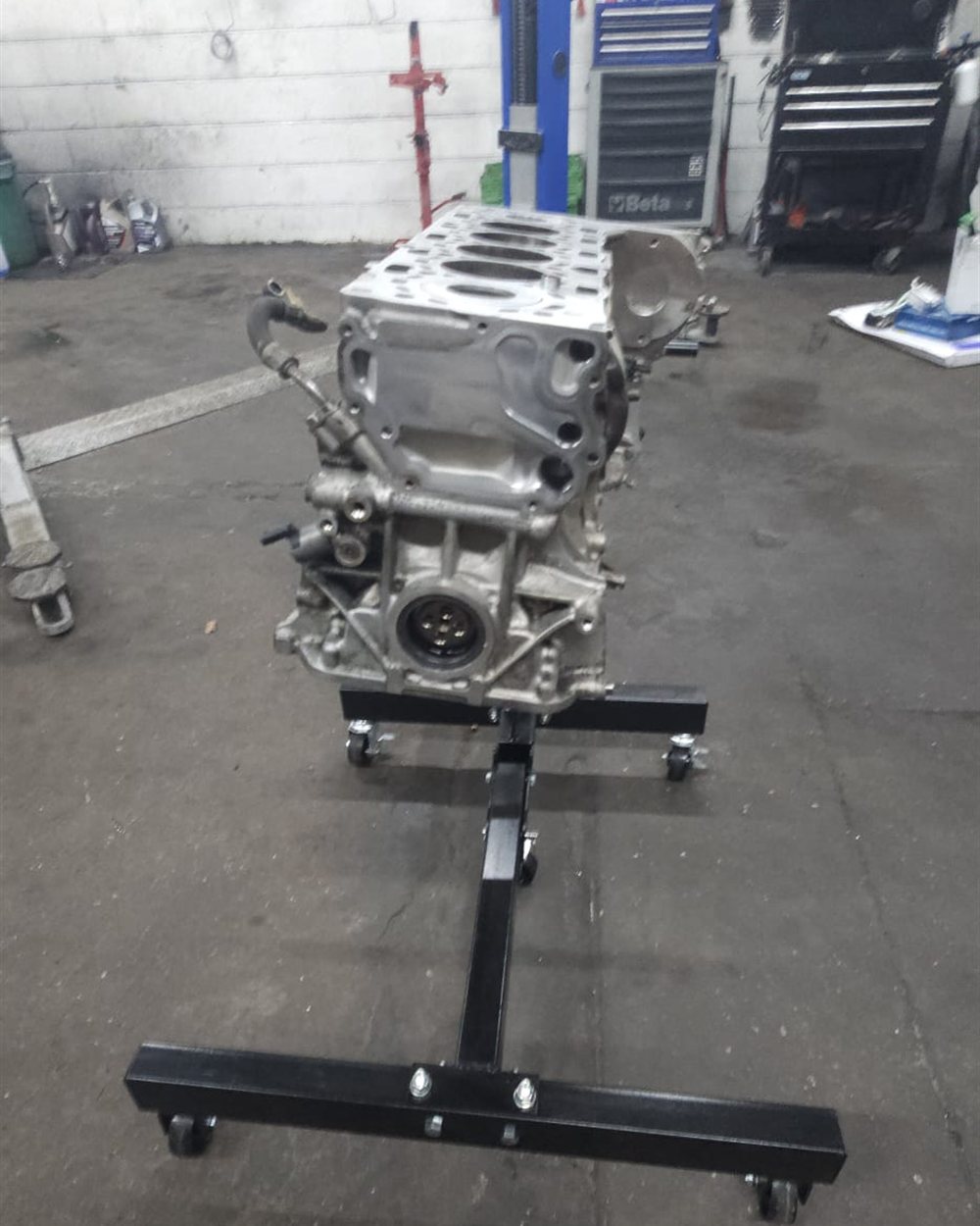 An engine block mounted on the stand for reconditioning