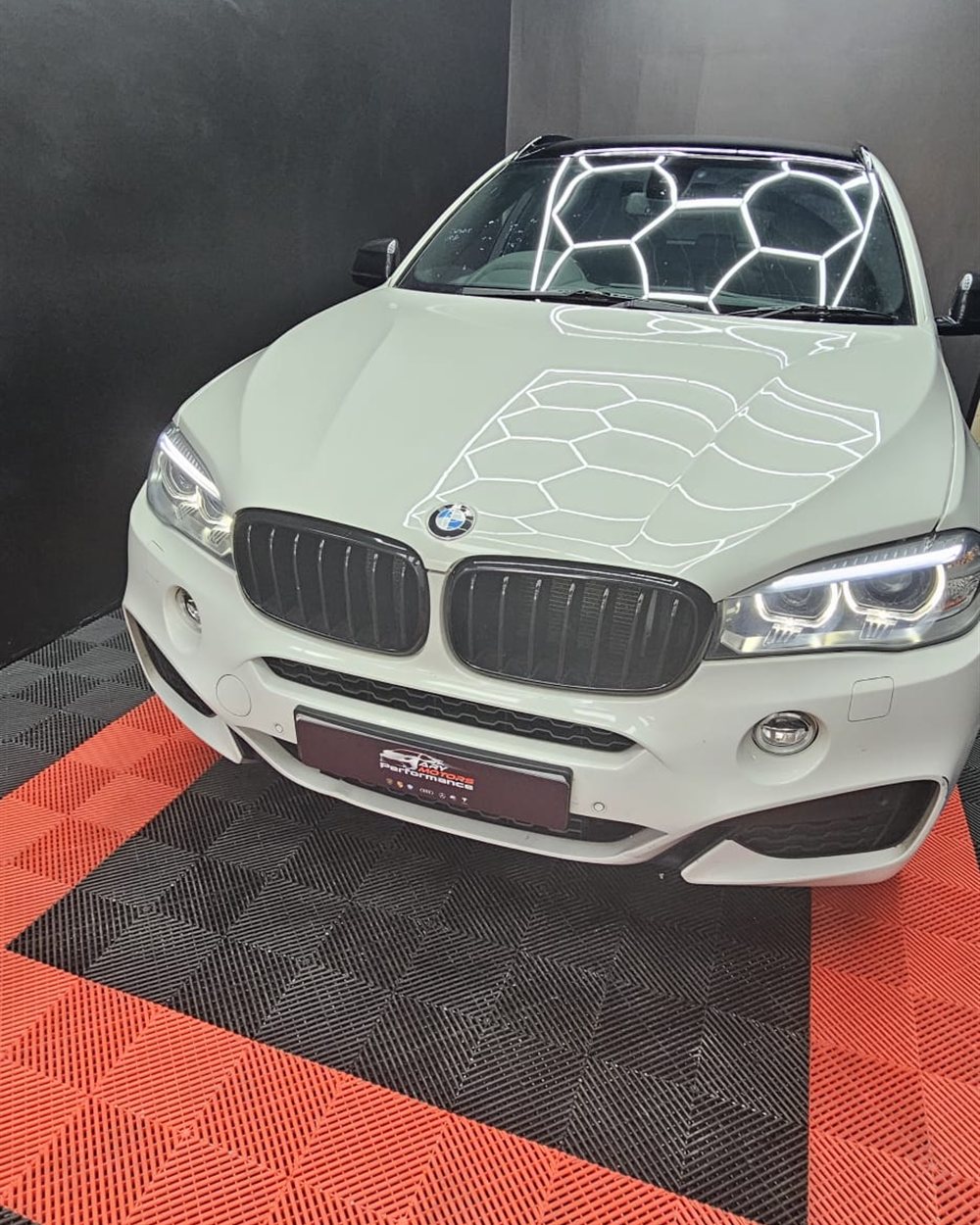 A finished car photographed head on in the workshop