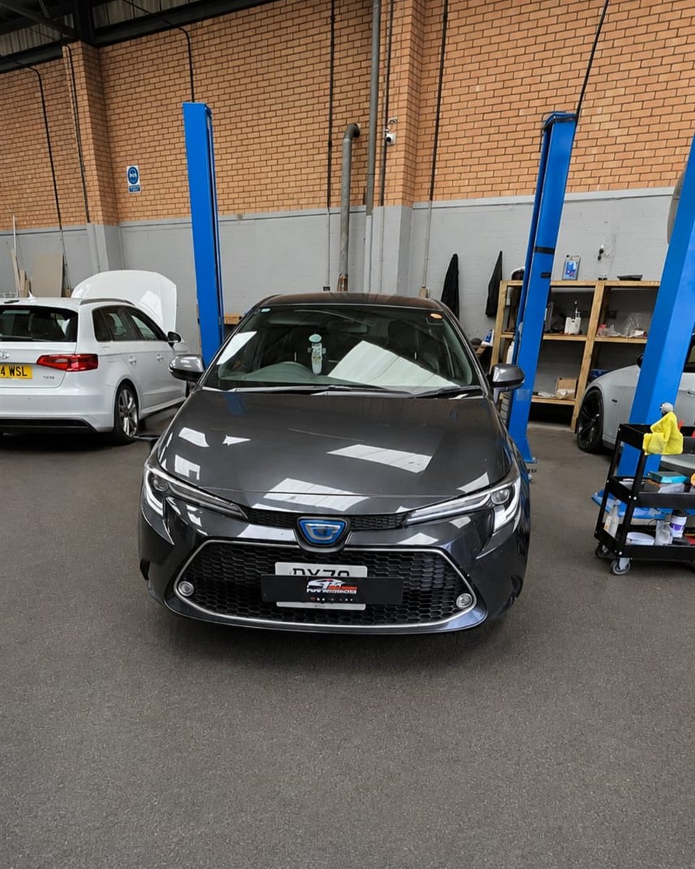 Cars in for work inside the Birmingham workshop